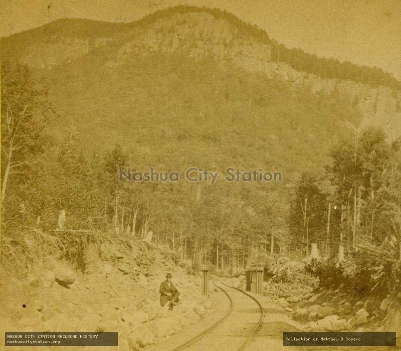 Stereoview: Frankenstein Cliff, Portland & Ogdensburg Railroad Crawford Notch, New Hampshire (from Bemis Brook)